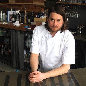 Nickolas Illingworth stands at fhe front counter of Lurra Cocina restaraunt at 1420 Locust in downtown Des Moines.