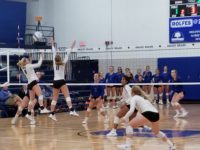 Madison Paulsen and Lacey Clark rise for the block