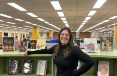 Librarian Emma Adams poses in the library, located in Building 6. Photo by Katie Hirth.